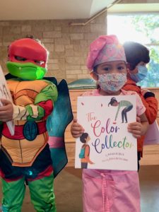 Children holding the book "The Color Corrector"